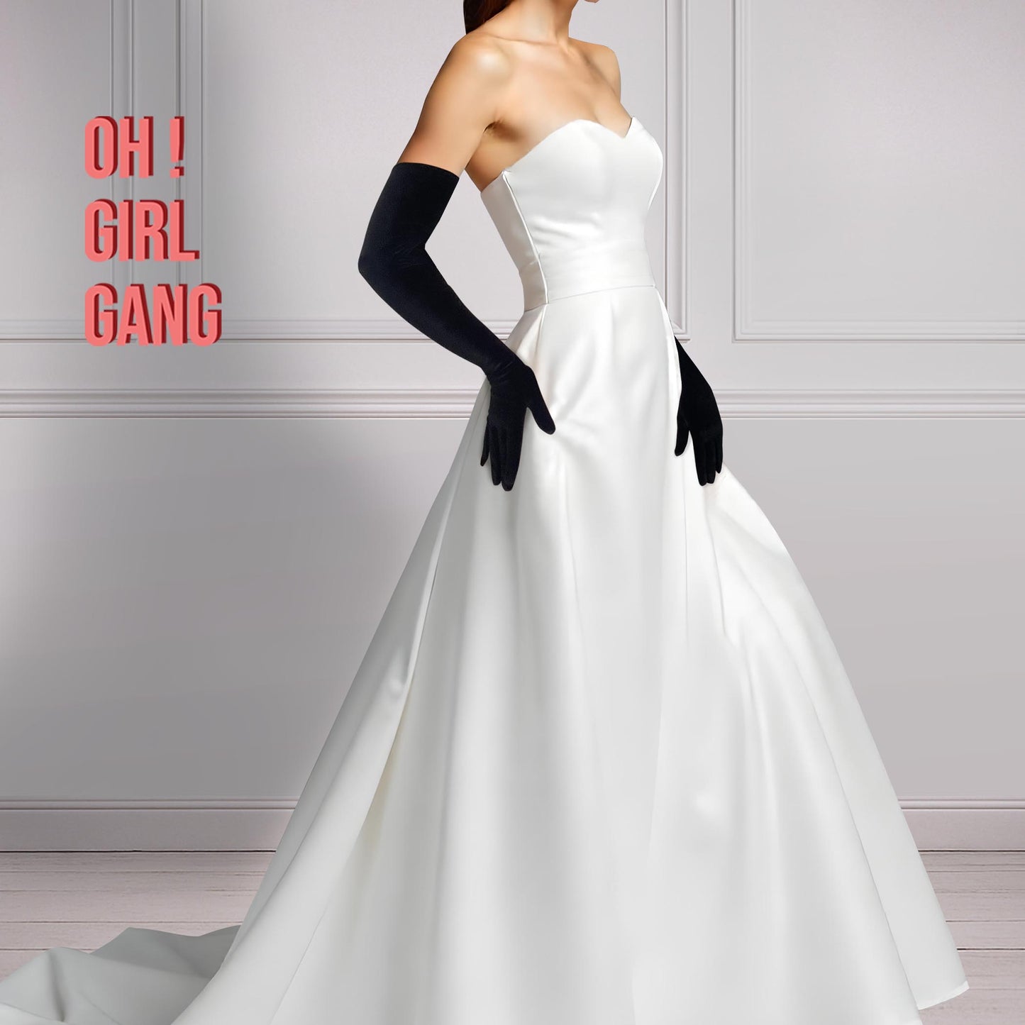 Pair of black velvet opera gloves shown on arm; smooth plush finish in 60 cm classic length, styled with a white evening gown.
