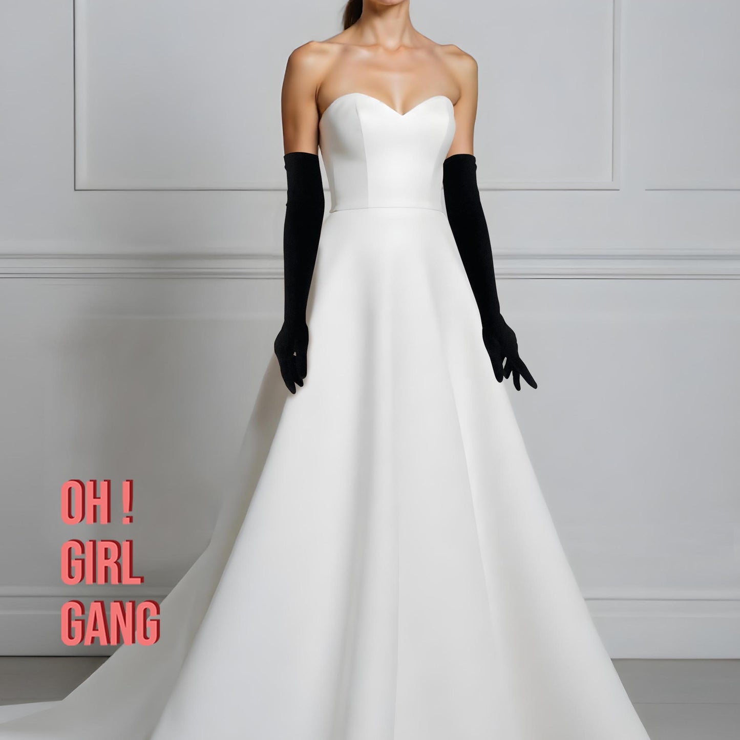 Pair of black velvet opera gloves shown on arm; smooth plush finish in 60 cm classic length, styled with a white evening gown.