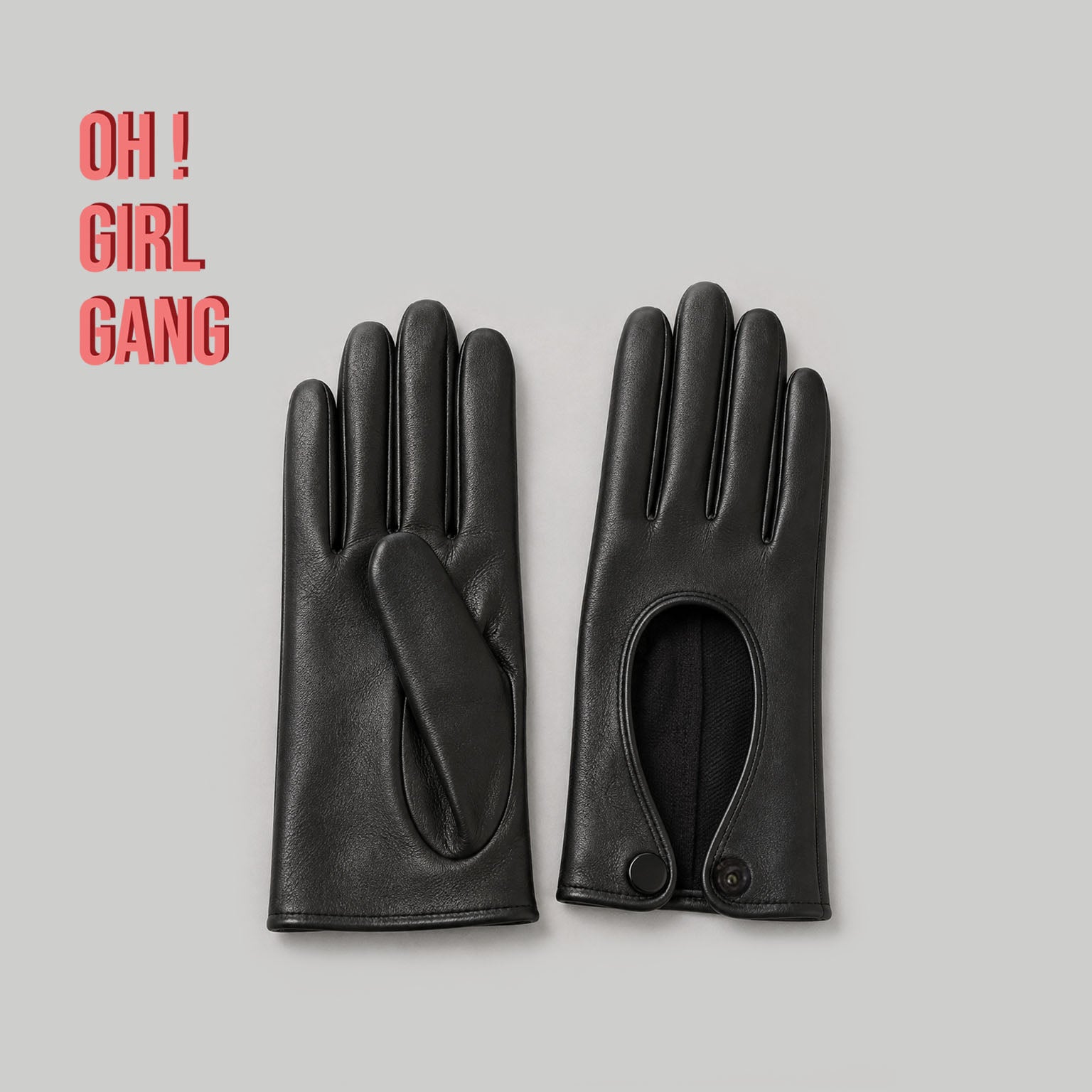 Pair of genuine leather driving gloves in burgundy, white, black, featuring an elegant open-back teardrop cutout with snap-button closure. Soft premium leather with a classic vintage-inspired design, displayed on a light grey background.