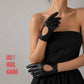 Pair of genuine leather driving gloves in burgundy, white, black, featuring an elegant open-back teardrop cutout with snap-button closure. Soft premium leather with a classic vintage-inspired design, displayed on a light grey background.