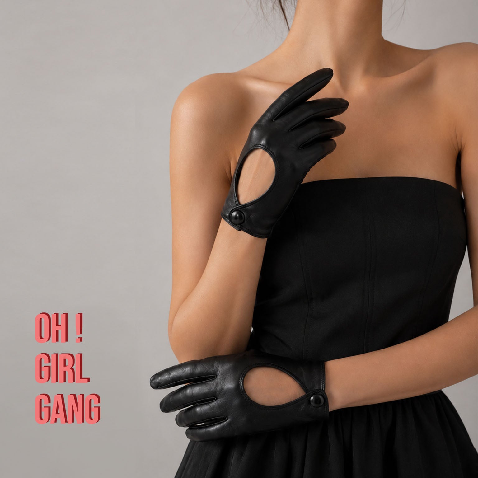 Pair of genuine leather driving gloves in burgundy, white, black, featuring an elegant open-back teardrop cutout with snap-button closure. Soft premium leather with a classic vintage-inspired design, displayed on a light grey background.