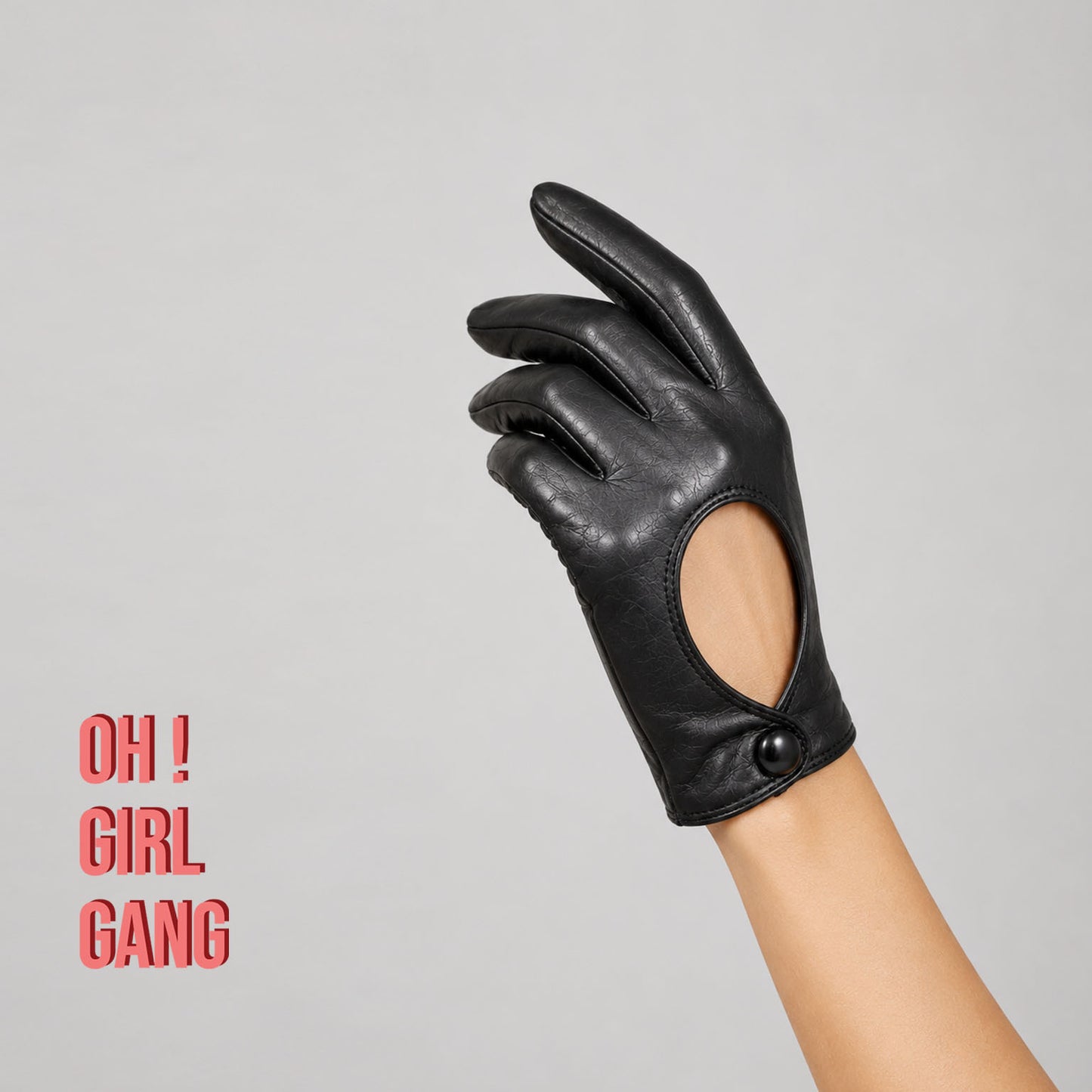Pair of genuine leather driving gloves in burgundy, white, black, featuring an elegant open-back teardrop cutout with snap-button closure. Soft premium leather with a classic vintage-inspired design, displayed on a light grey background.